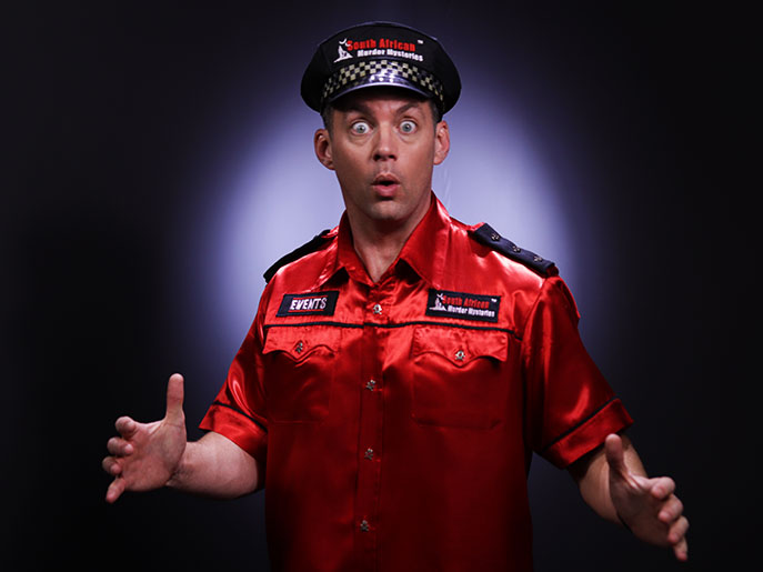 A surprised looking Murder Mystery Detective in a red shirt